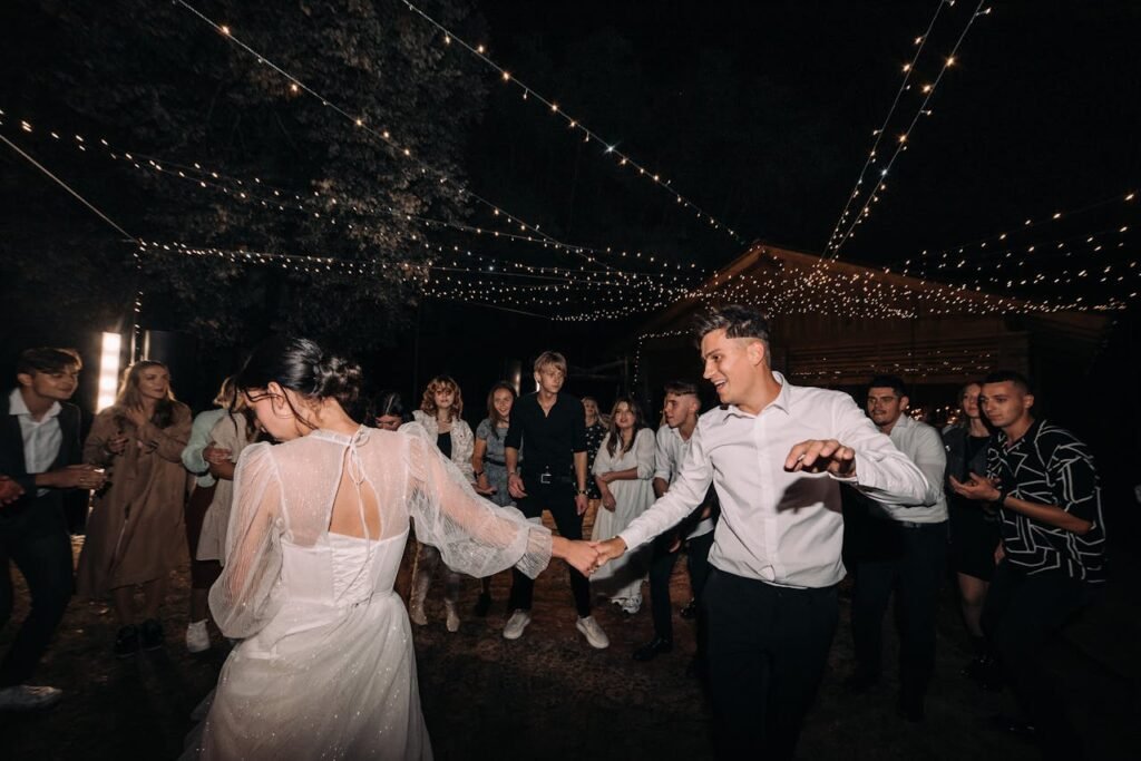 zipwp-image-15964956 Newlyweds Dancing in a Crowd at Night